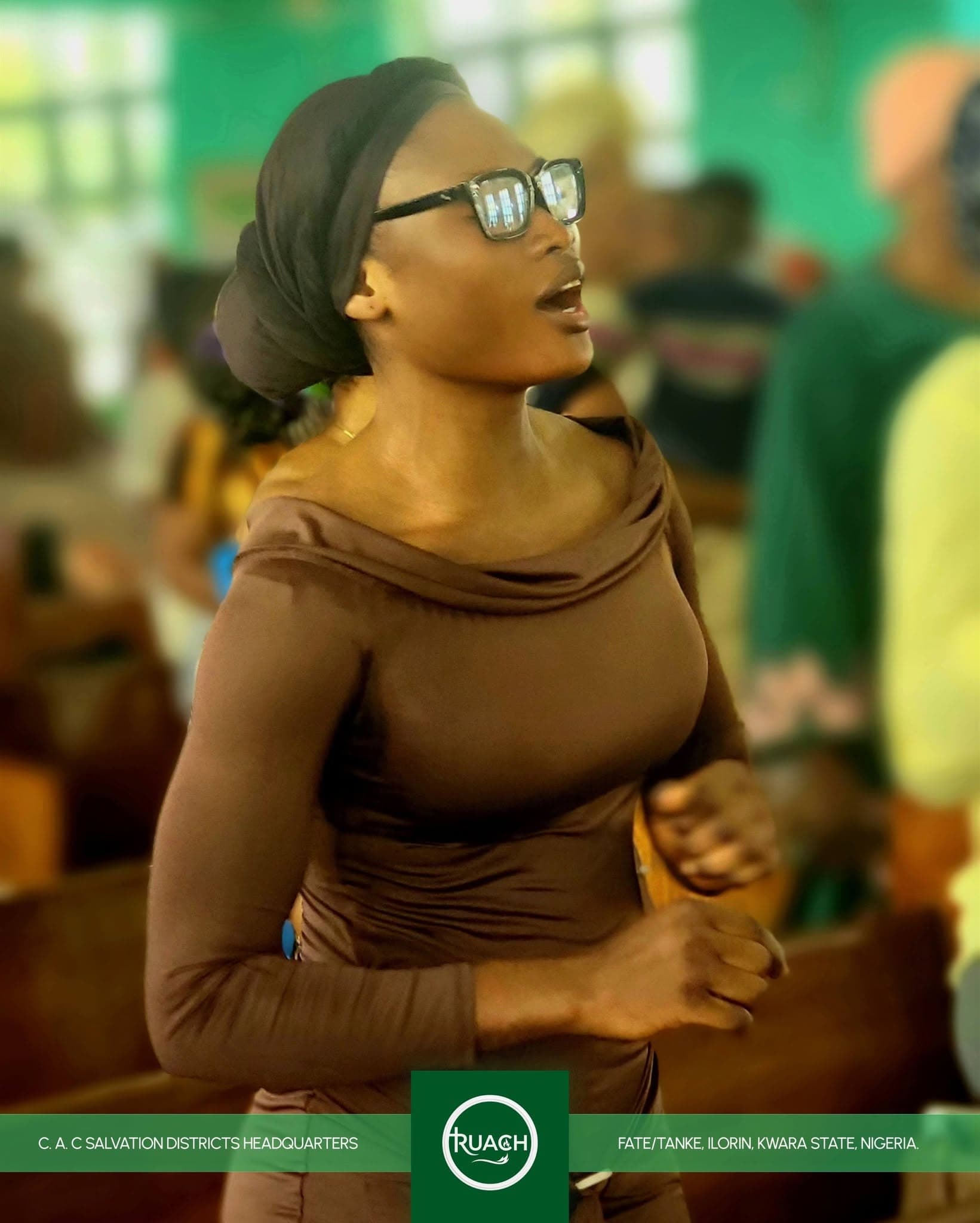 A member of the congregation singing during worship at C.A.C Salvation Centre, Ilorin